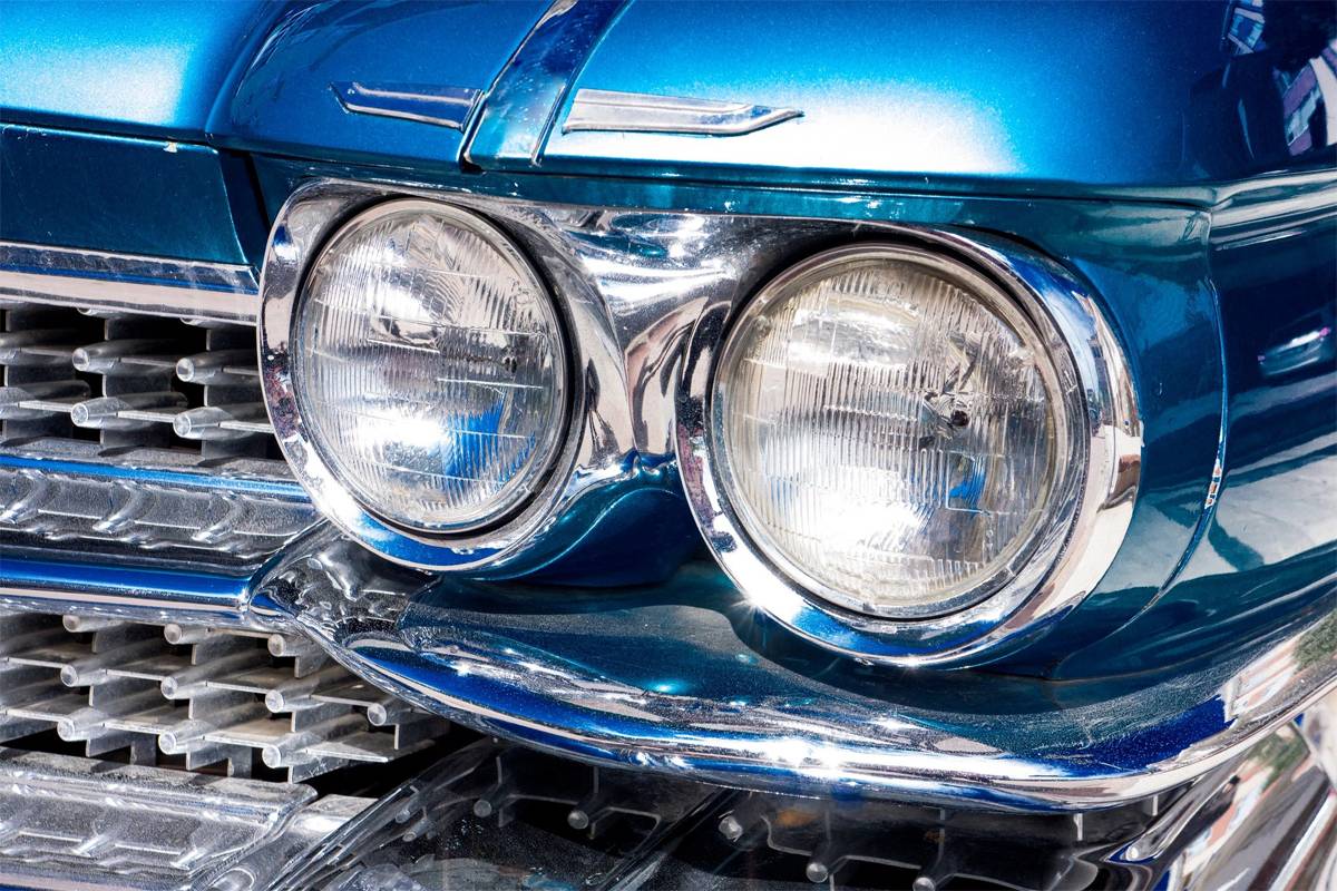 A close up view of a vintage car with round headlights